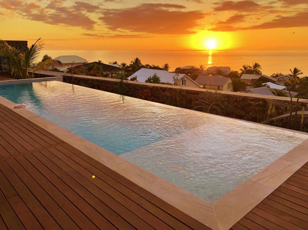 Piscine au coucher de soleil face à l'océan