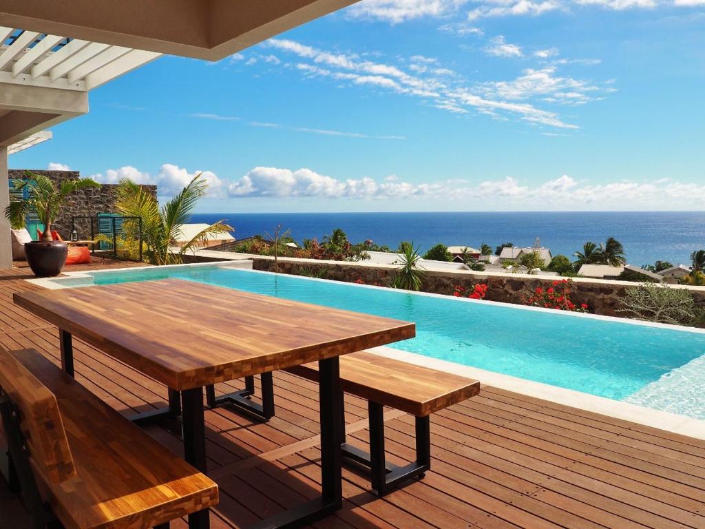 Table extérieure en bois face à la piscine